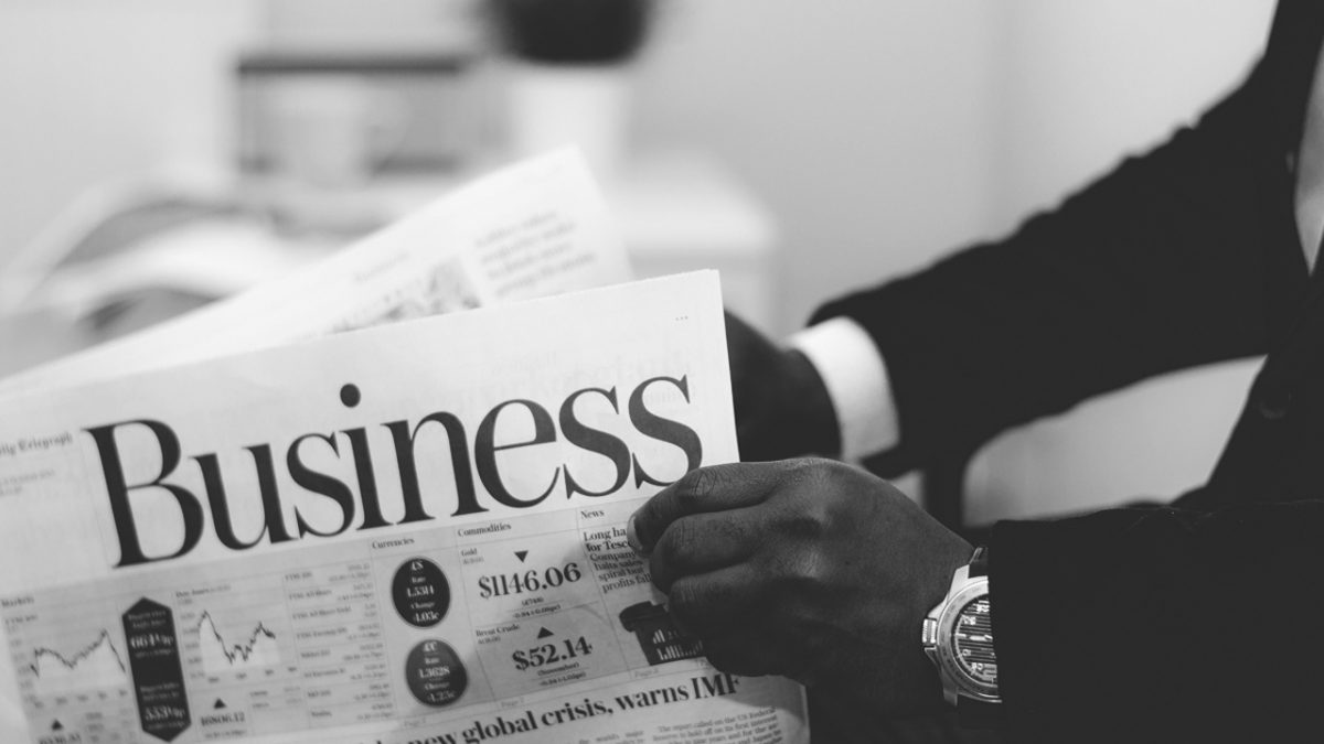 Man holding business newspaper