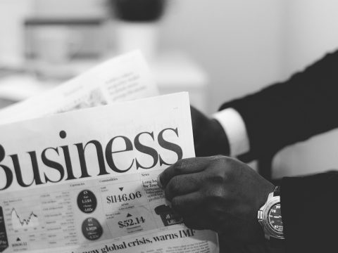 Man holding business newspaper