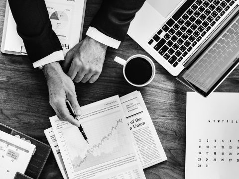 man in an office reviewing a financial document