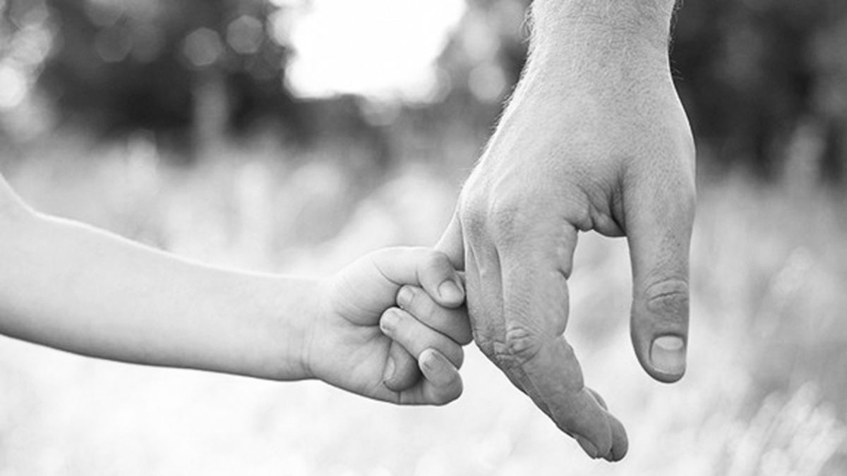 Parent holding child's hand